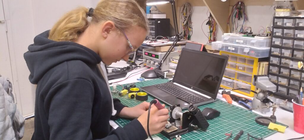 Soldering the wires to the different parts of the circuit. 